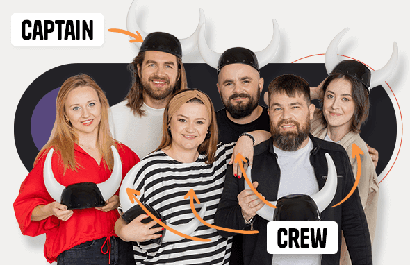 Six Vikings wearing helmets smile mischievously
